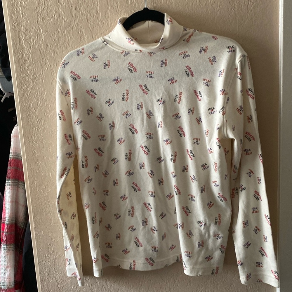 Cream trick or treat turtleneck